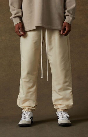 Fear of God Essentials Egg Shell Track Pants | PacSun