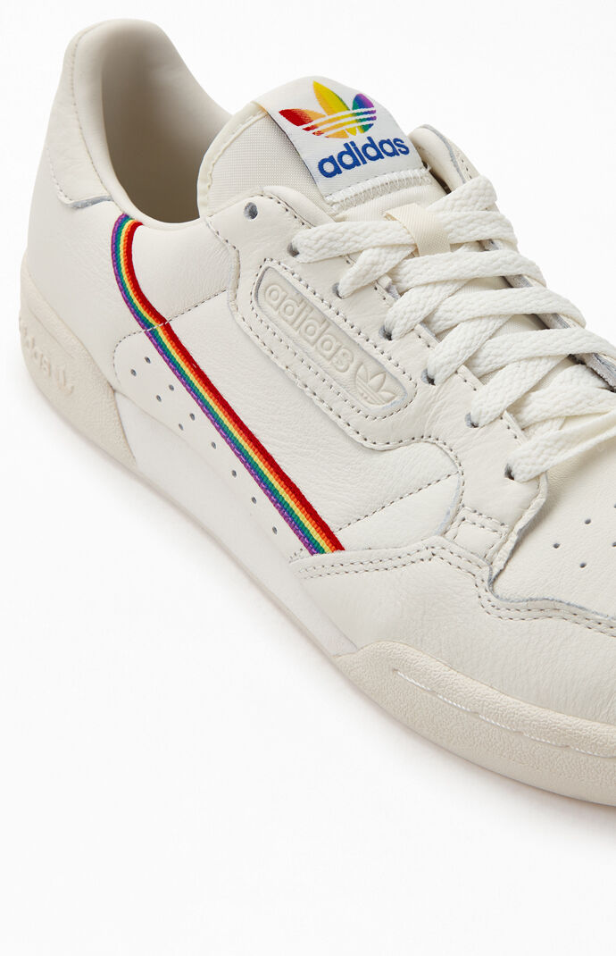 white adidas shoes with rainbow stripes